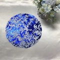 Detailed view of the blue marble texture and metallic silver finish on a round placemat - Sapphire Blue