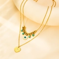 Close-up of double-layer gold necklace featuring turquoise beads and evil eye pendant - Gold Double Chain Heart Necklace