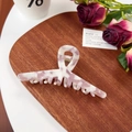 Pink and white marble texture acetate shark hair claw clip for women on a table - 11.5CM / Jewel Purple