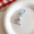 Close-up of cute astronaut character keychain in blue spacesuit on a white plate - Blue Dog