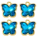 Macro view of four sky blue crystal butterfly pendants with golden metal edges - Sky Blue