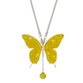 Macro shot of silver metal butterfly car pendant with yellow crystals and a small NU charm - Lemon Yellow