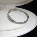 Silver double-row crystal open bangle with sparkling stones on velvet display - Silver