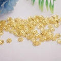 Macro shot of 14K gold plated hollow floral spacer beads for DIY jewelry making - 6mm Hollow Bead Cap / 18K Gold