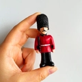 3D British Royal Guard fridge magnet with red uniform and black hat on white background - (82) UK Soldier