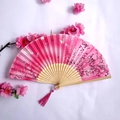 Pink folding fan with cherry blossoms and butterfly patterns, featuring a pink tassel - Pink Cherry Blossom Butterfly Style (Women's Fan - 51)