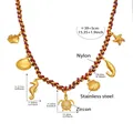 Macro view of ocean themed stainless steel charms with turtle zircon inlay detail - 41+5cm / Gold DIY Multi-Charm Necklace (P014)