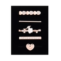 Detailed view of 5-piece rose gold rhinestone hair clip set on black velvet card - D3016 Heart/Flower Set 6
