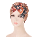 Detail of bohemian snail-style turban with ethnic orange and brown geometric print - Orange