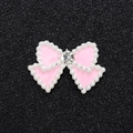 Macro detail of pink bow charm with pearl border and sparkling center rhinestone - Silver Base Pink Bow