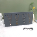 Gray necklace display board with black hooks on white faux fur and green background - Vertical 16-hook Necklace Rack / Gray
