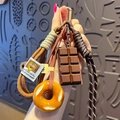 Creative chocolate and donut pretzel keychain with hand-woven rope and bronze hardware - Pretzel-Bagel + Chocolate