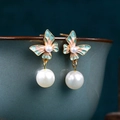 Macro shot of gradient enamel butterfly earrings with hanging white pearls on ceramic - CP982-Green Pink Butterfly