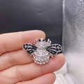 Silver bee brooch with sparkling rhinestones and black enamel detail in hand - Style 20