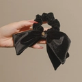 Elegant black velvet bow scrunchie with a small gold pendant detail for women - Black