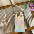 Close-up of peach pattern knitting and metal button closure on the light blue crossbody bag - Blue and Pink Tulip - Phone Bag