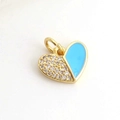 Close-up of heart-shaped charm with blue enamel and pave-set zircons on gold metal - Blue