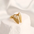 Gold open wing ring with white enamel feathers on a rustic white stone surface - Adjustable Open / 18K Gold Plated Wings White