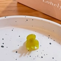 Mini translucent yellow-green hair claw clip on a decorative white ceramic plate - Lemon Yellow