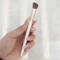 Angled eyeshadow brush with white handle and gold ferrule held for eye makeup - Nose Contour Brush