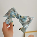 Light blue silk headband with hand-painted patterns and a large bow design - Blue Dragon Print Bow Headband