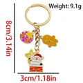 Christmas keychain with gingerbread man and santa charms in gold finish, 8cm height - ER1777-Gift Box Gingerbread Man Santa Keychain