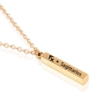 Macro detail of gold Sagittarius pillar pendant necklace with engraved zodiac symbol - Gold Sagittarius