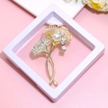 Golden ginkgo leaf brooch with crystals and pearl detail on a white display stand - XZ143-Gold Ginkgo Leaf-Boxed