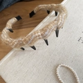 Close-up of brown knit wavy headband on a vintage book with warm aesthetic details - Light Coffee