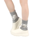 Detail showing grey knitted leg warmers with white skull patterns and casual shoes - One Size / Light Gray