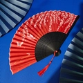Classic red folding fan with white cherry blossoms, black bamboo ribs and red tassel decoration - Red Cherry Butterfly Wave