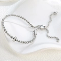 Detail of silver twisted rope bracelet with a micro-pave zircon ring and sliding clasp - Zircon Cable Bracelet / Steel