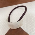 Brown hair tie featuring a pearlescent white acetate curved buckle with gold engraving - Mermaid White