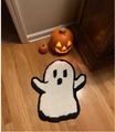 Ghost-shaped plush Halloween doormat on wooden floor with glowing pumpkins - Little Ghost 2