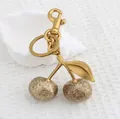 Golden cherry keychain pendant with glitter finish and lobster clasp for bags - Rich Gold Matte Cherry with Bronze Gold