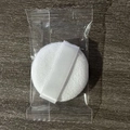 Single white velvet powder puff with ribbon handle on dark wood surface in clear bag - Candy Bag 35x7mm / White