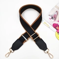 Close-up of black cotton bag strap with brown leather trim and golden metal hooks - Gold Buckle / Black & Brown Edge + Black Leather