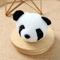 Close-up of a cute plush panda head ornament on a natural wooden tray with a sandy background - Panda Plush Brooch