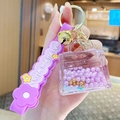 Purple bubble tea bear keychain with liquid glitter, gold bell and soft rubber strap - Pearl Handbag - Purple