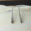 Elegant silver drop earrings with pavé set crystals on a textured shell plate - White Gold
