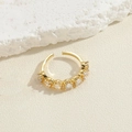Adjustable gold open ring with seven sparkling white zircons in a claw setting - Adjustable Open / White
