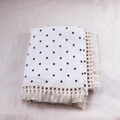 Close-up of soft double-layer cotton baby blanket with black star print and tassel edge - 100x120cm / Pentagram