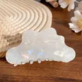 Elegant white pearlescent cloud hair claw clip with iridescent finish on wooden surface - Gem White