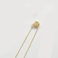 Delicate gold necklace with square pendant featuring diamond letter 'n' on cream background - Letter U (XL3420)