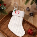 White knit Christmas stocking featuring red embroidered letter O and textured cable pattern - Letter O