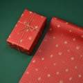 Red Christmas kraft wrapping paper featuring gold reindeer and Santa Claus patterns - Polka Dot Christmas