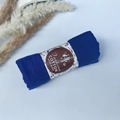 Detailed view of rolled dark blue pleated cotton scarf with floral gift packaging - Style #9