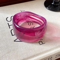 Purple marbled acrylic wide cuff bracelet with smooth resin finish on a vintage book - Purple