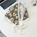 Detailed flat lay of green floral cotton scarf with white lace trim and ties - Frangipani Green Base