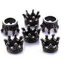 Detailed macro view of six vintage bronze alloy crown pendants on white background - Gunmetal